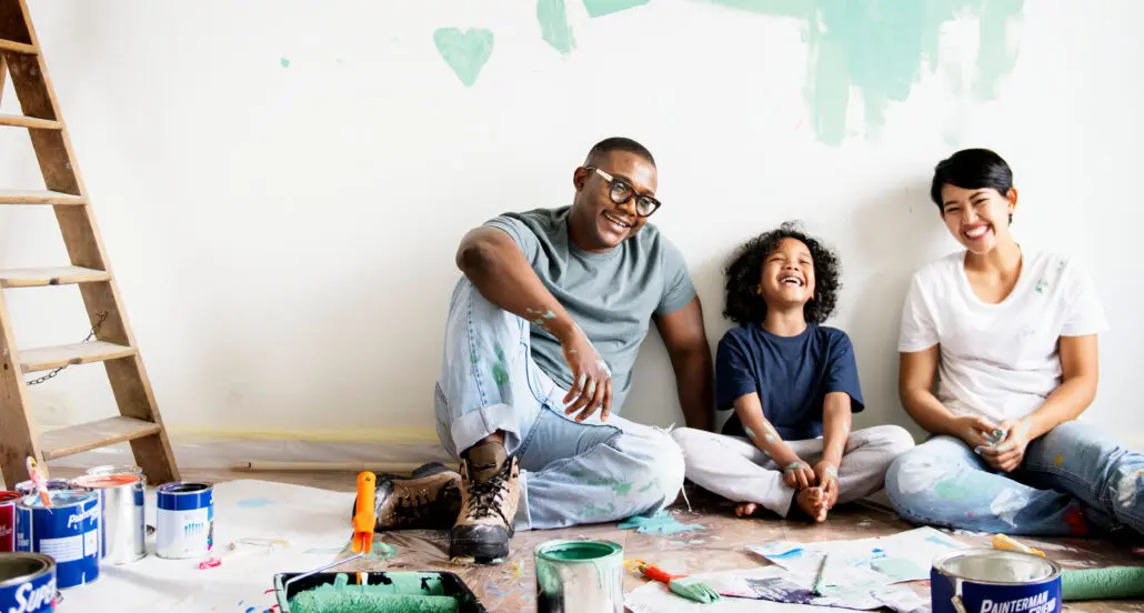 Joyful family building and painting together