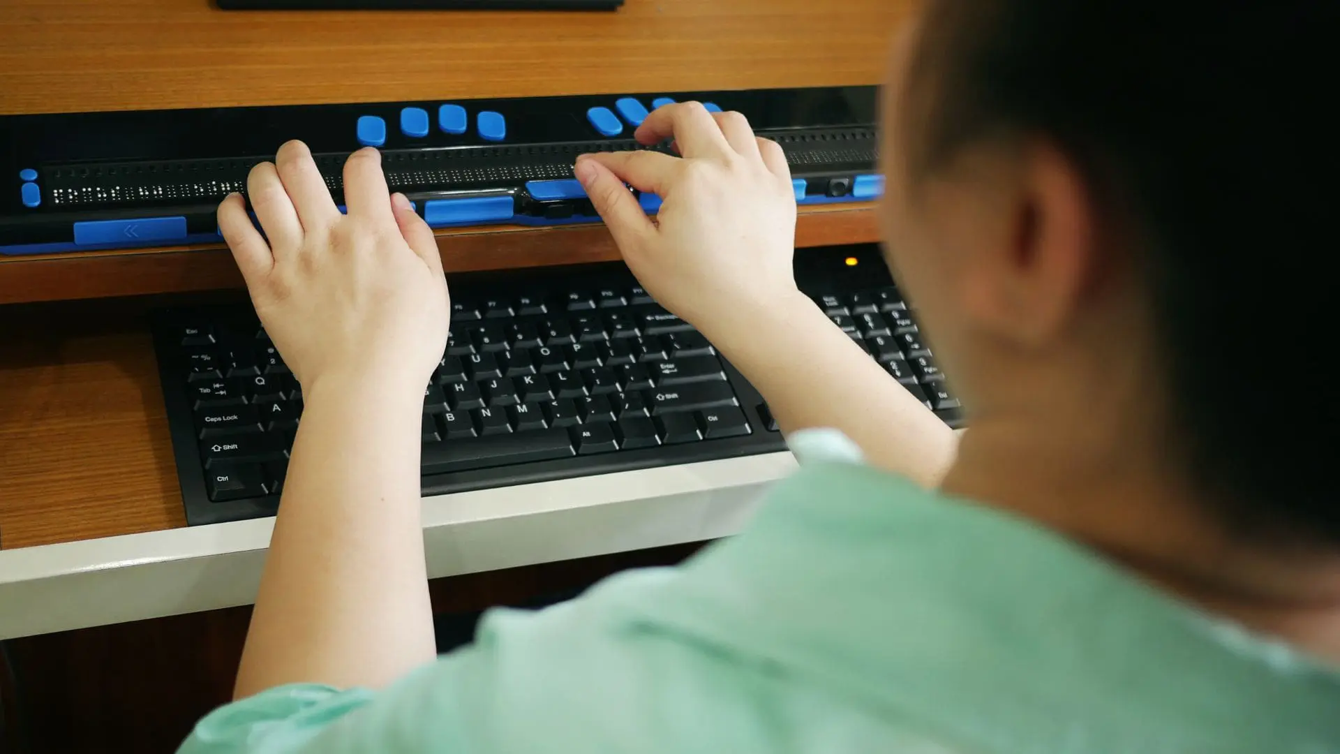 Person typing on keyboard.