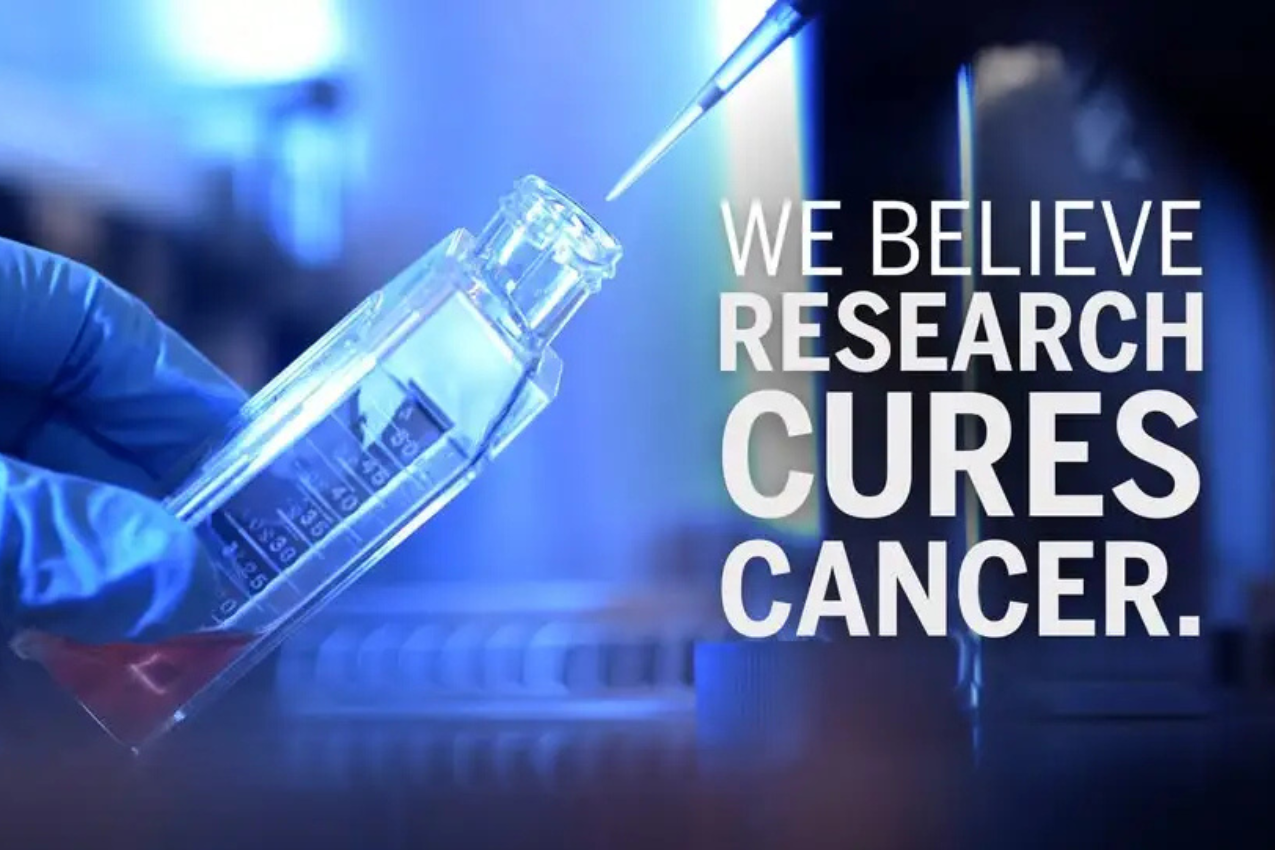 Lab tech wears blue gloves, holds a syringe. Text reads "We believe research cures cancer."