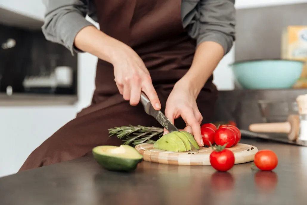 woman's hands slicing vegetables