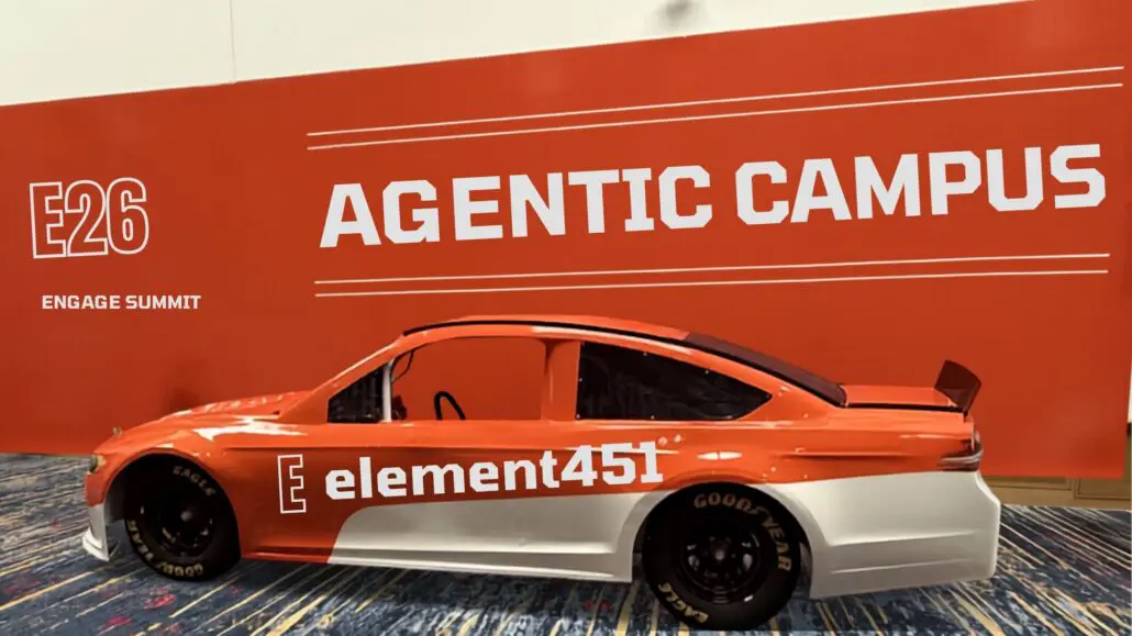 orange element451 race car sitting in front of large Agent Campus sign
