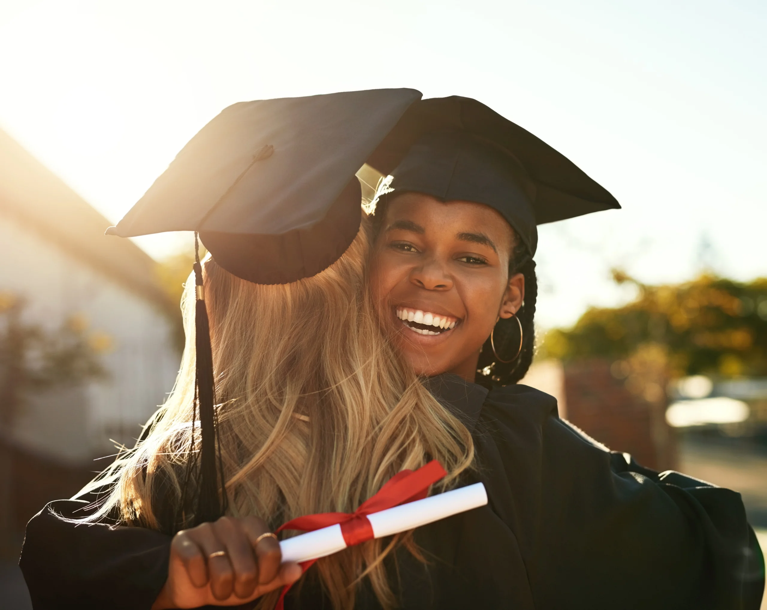 Two graduates hugging