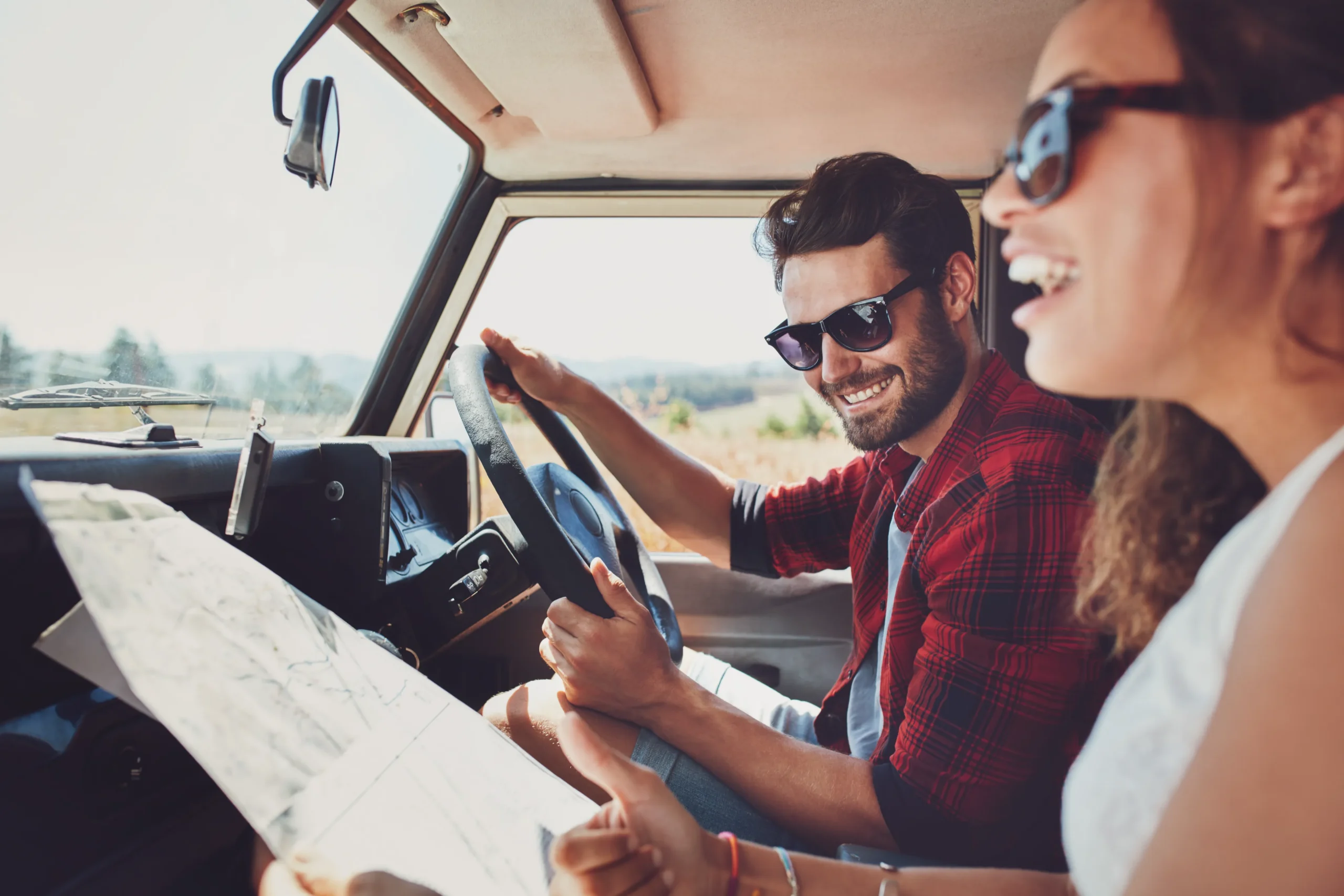 Man and woman reading a map in the car