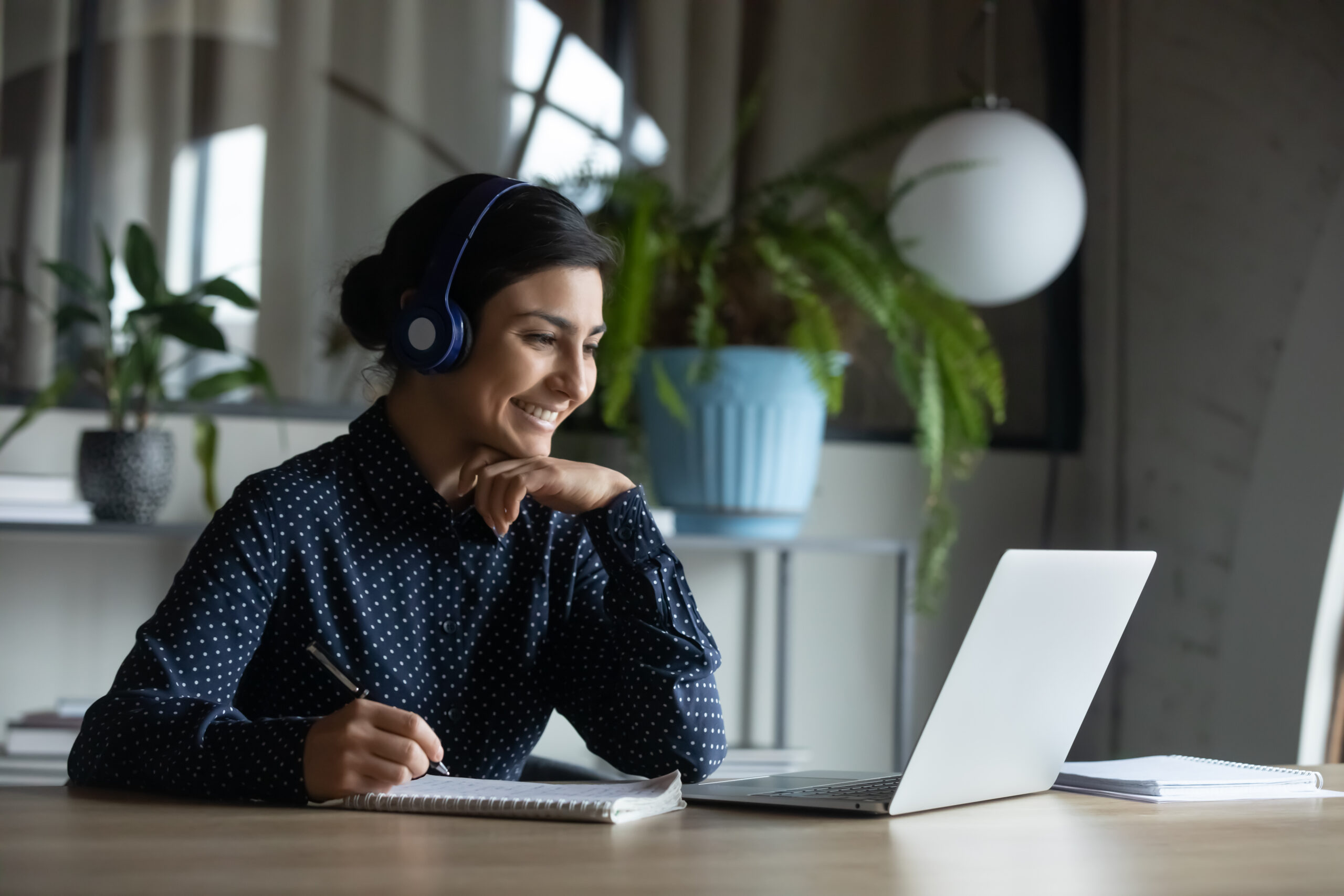 woman using headphones to do telehealth