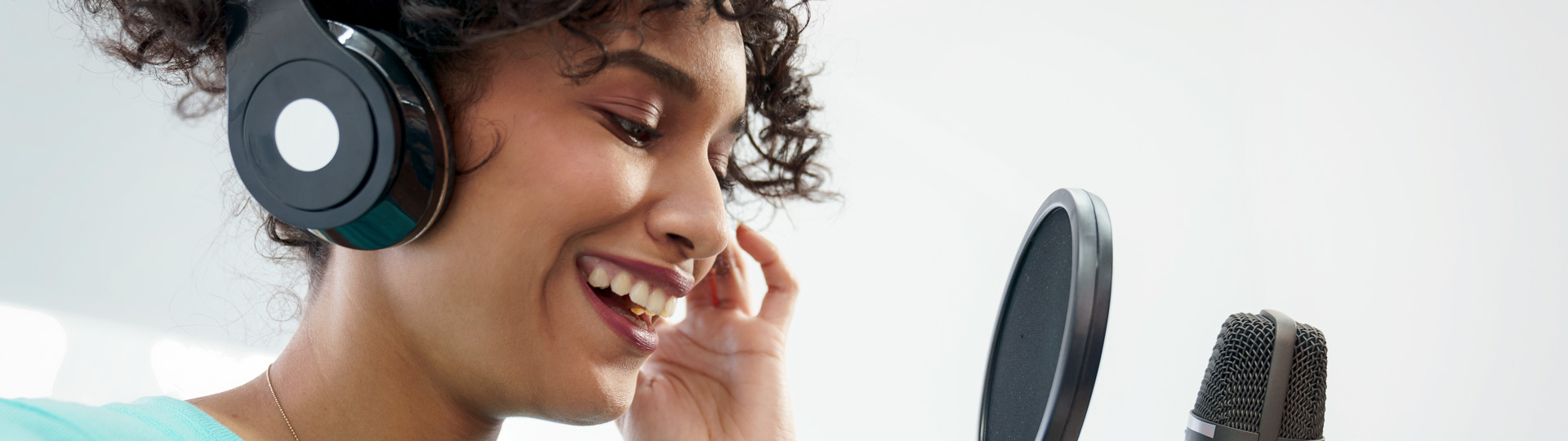 woman speaking into podcast microphone
