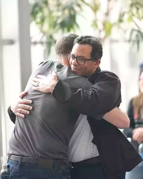 Two men hugging