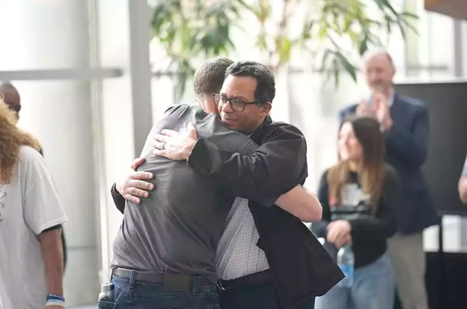 Dr Hanna embracing a patient