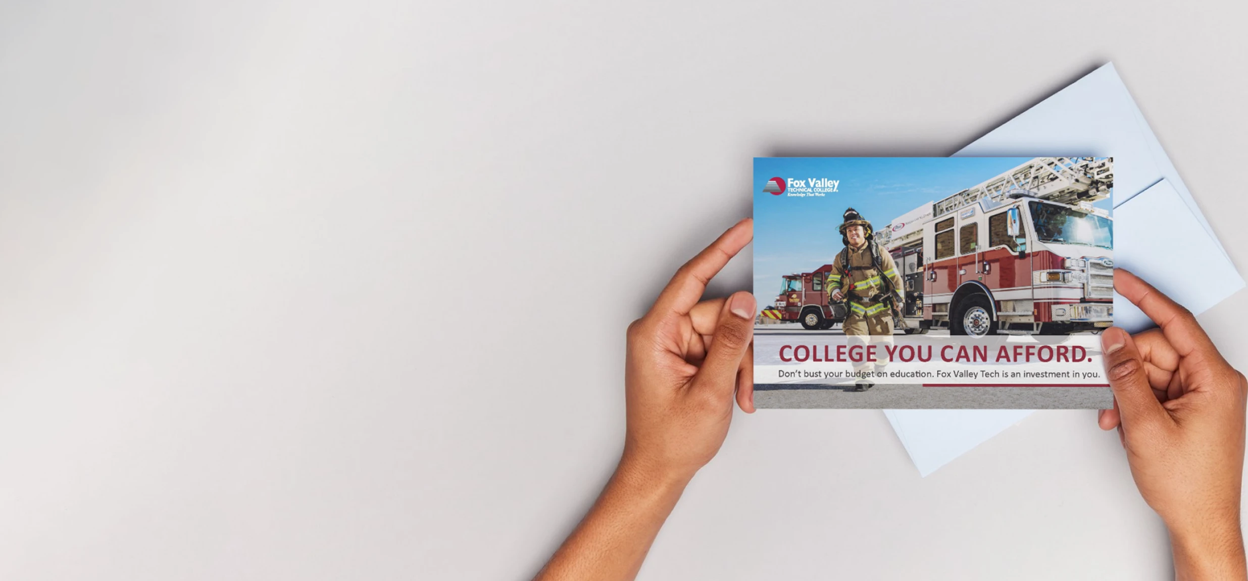 top view of hands holding postcard design for fox valley