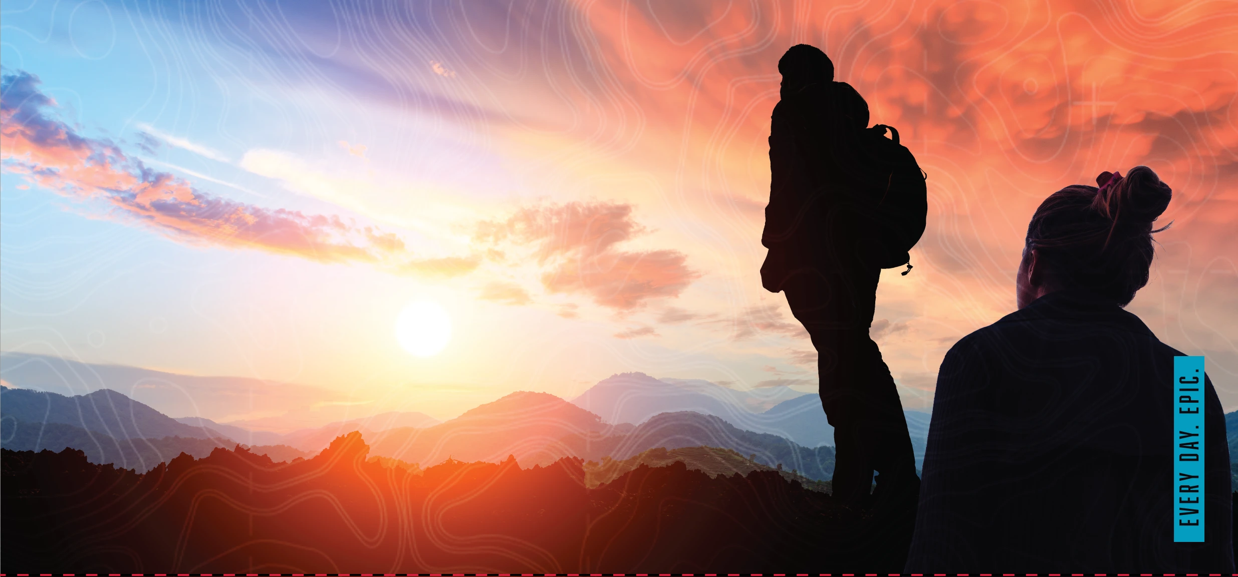 silhouette of two people on the summit of a mountain. Vivid sunset