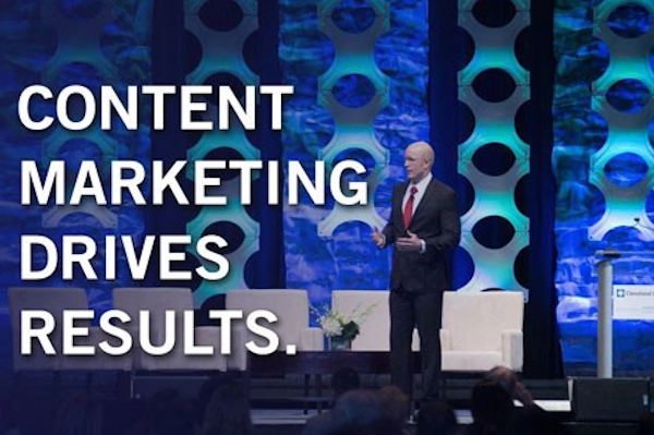 Male standing up on stage talking about Content Marketing Driving Results