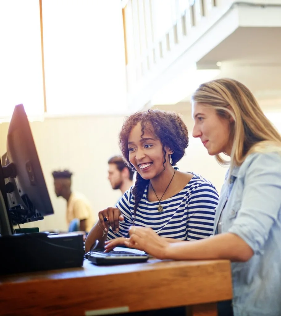 two women working on a computer