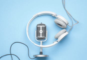 Podcast mic and headphones on a light blue background