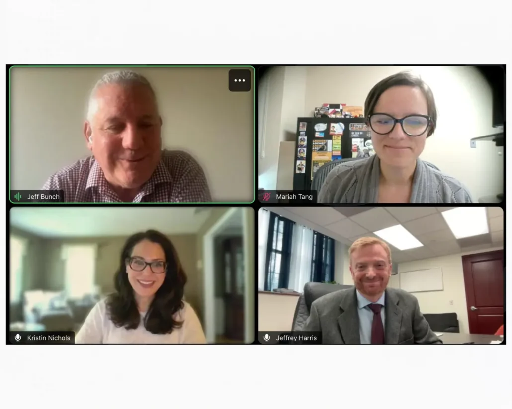 Image of four panelists smiling.