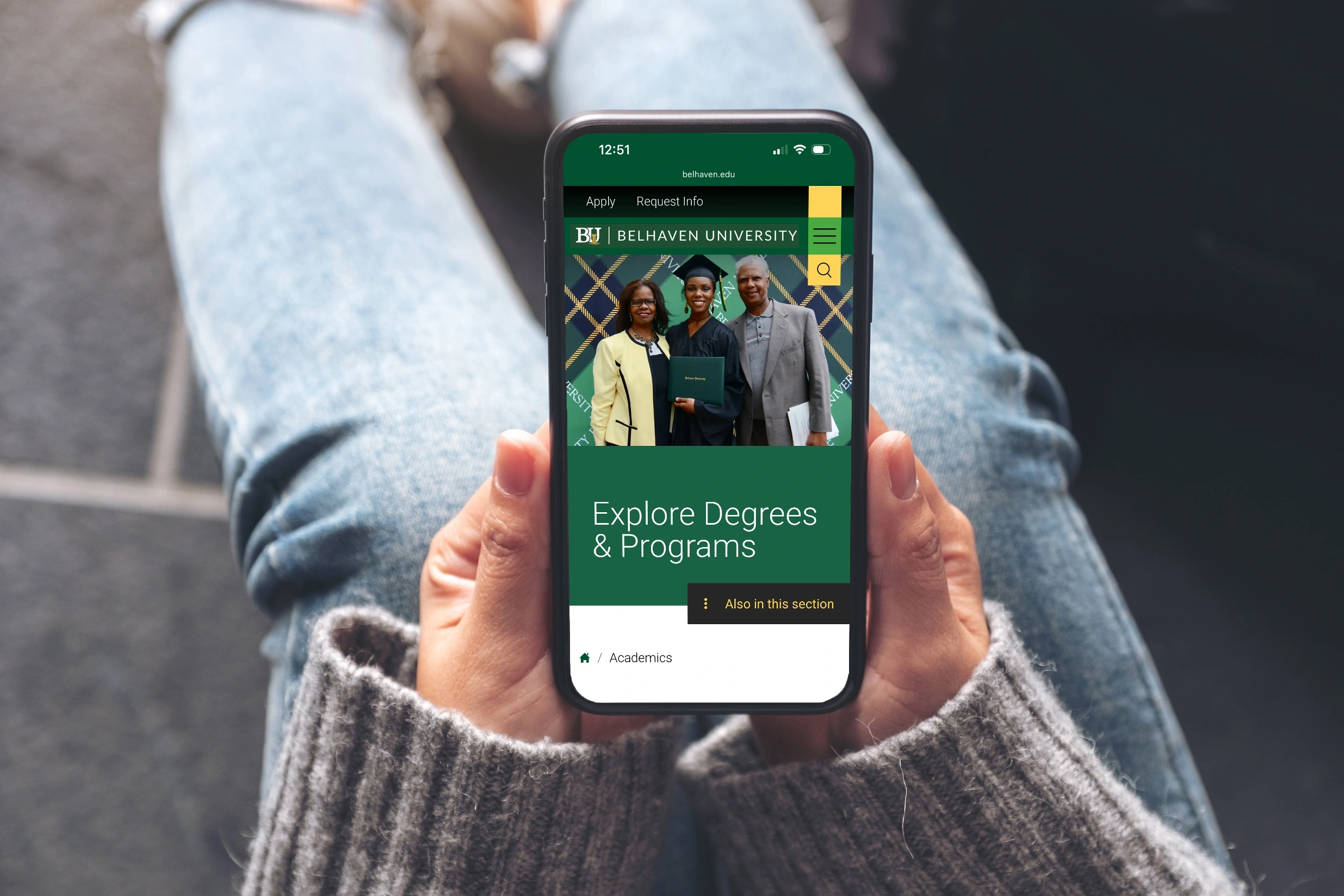 Top view of a mobile device in hands showing page of belhaven website