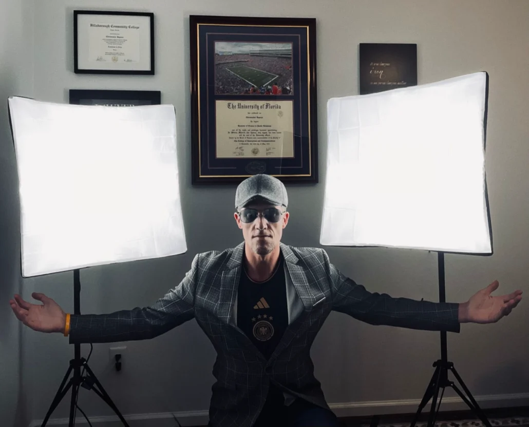 Chris Rapozo by two lighted video screens